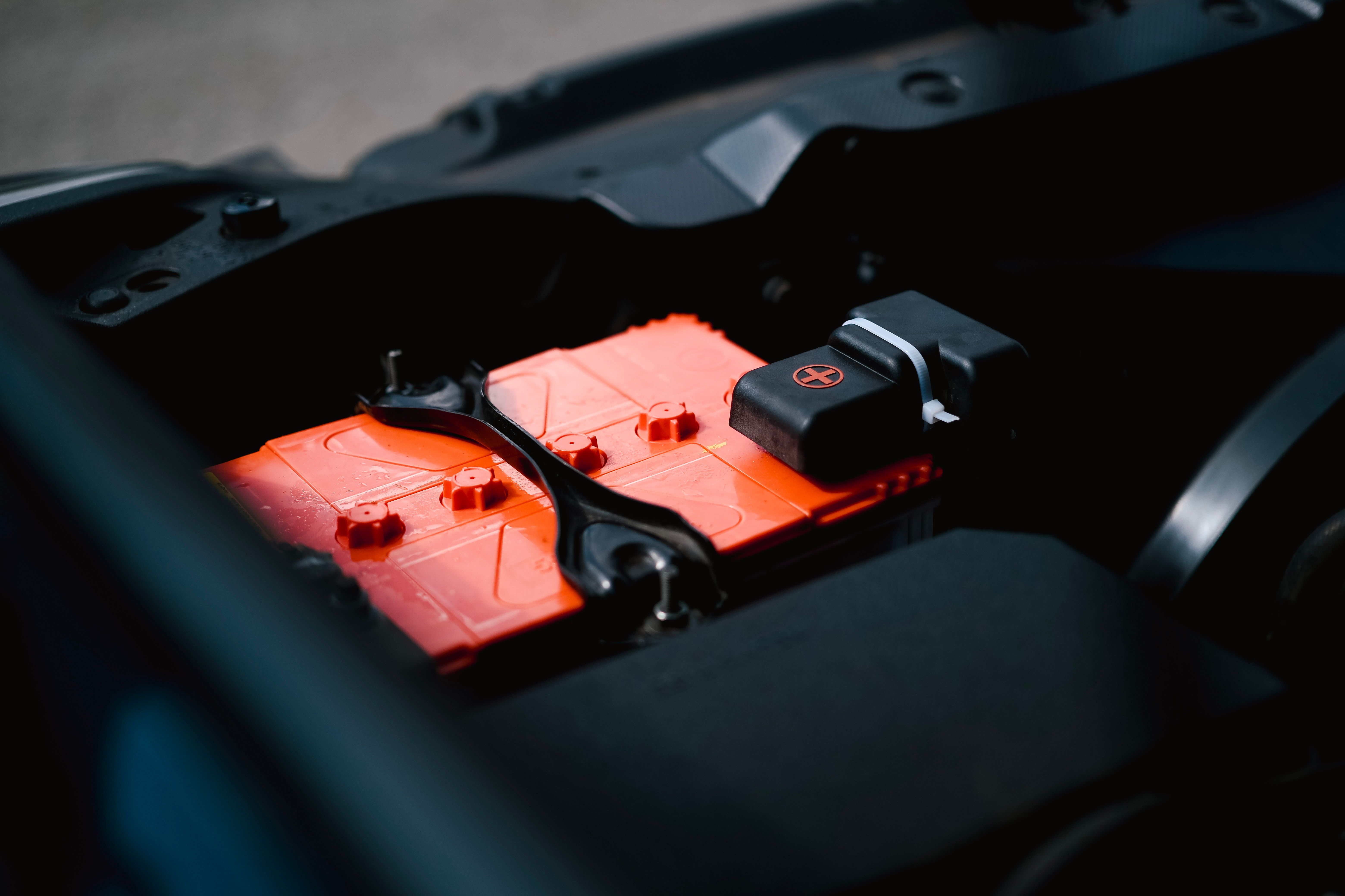 Digital multimeter measuring the voltage of a car battery