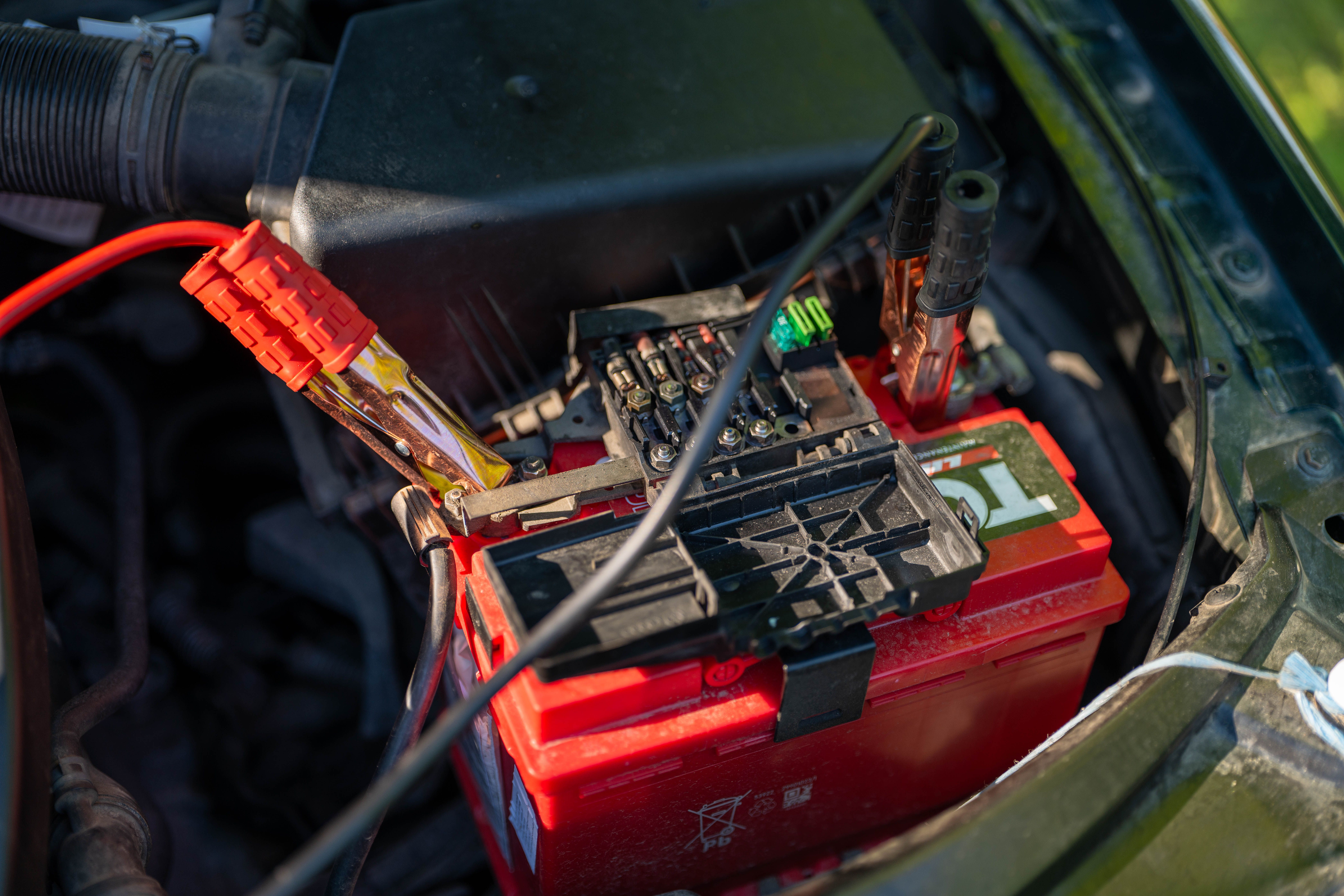 Cleaning corrosion from car battery terminals with a battery terminal brush