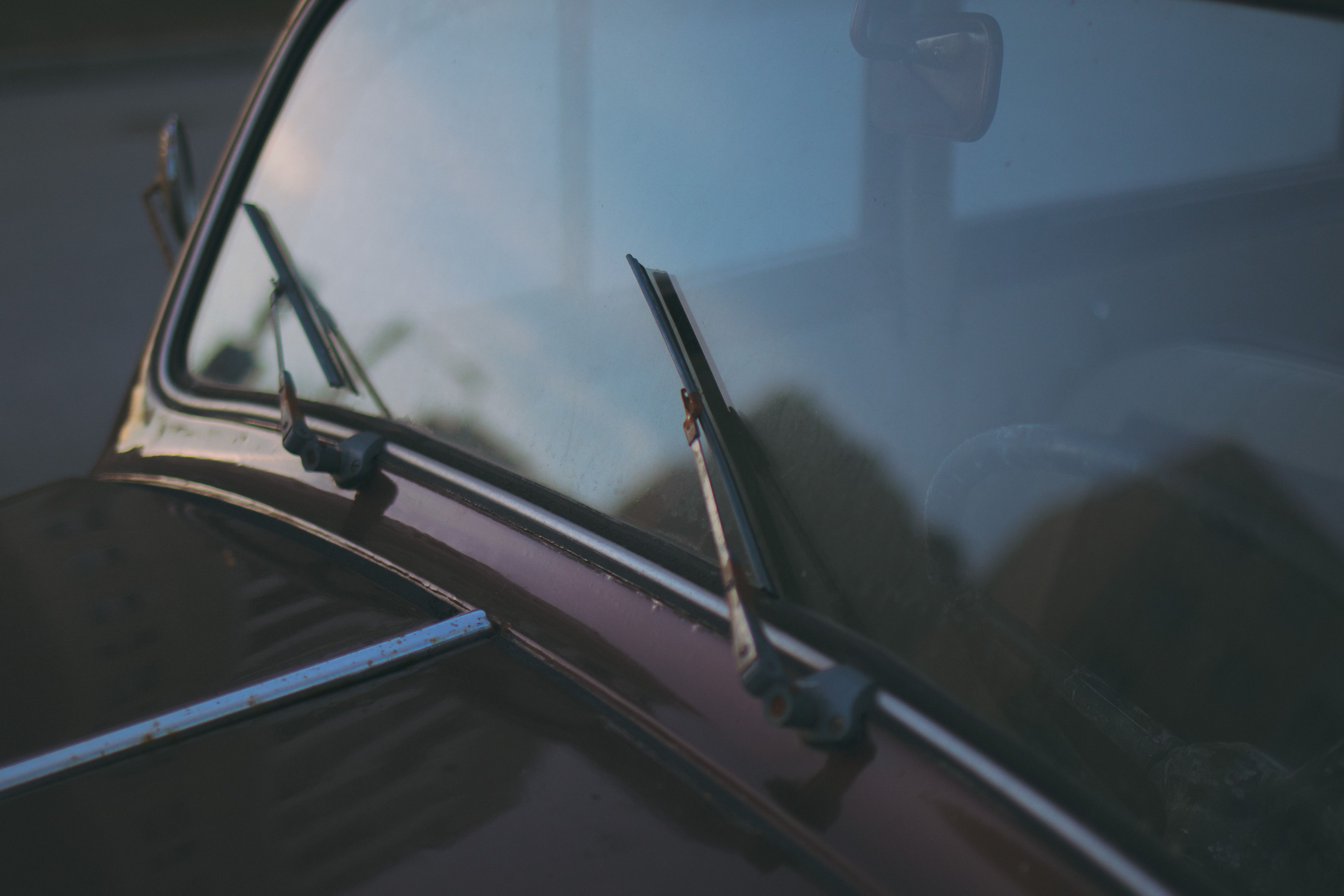 Inspecting squeaking windshield wiper blades on a car