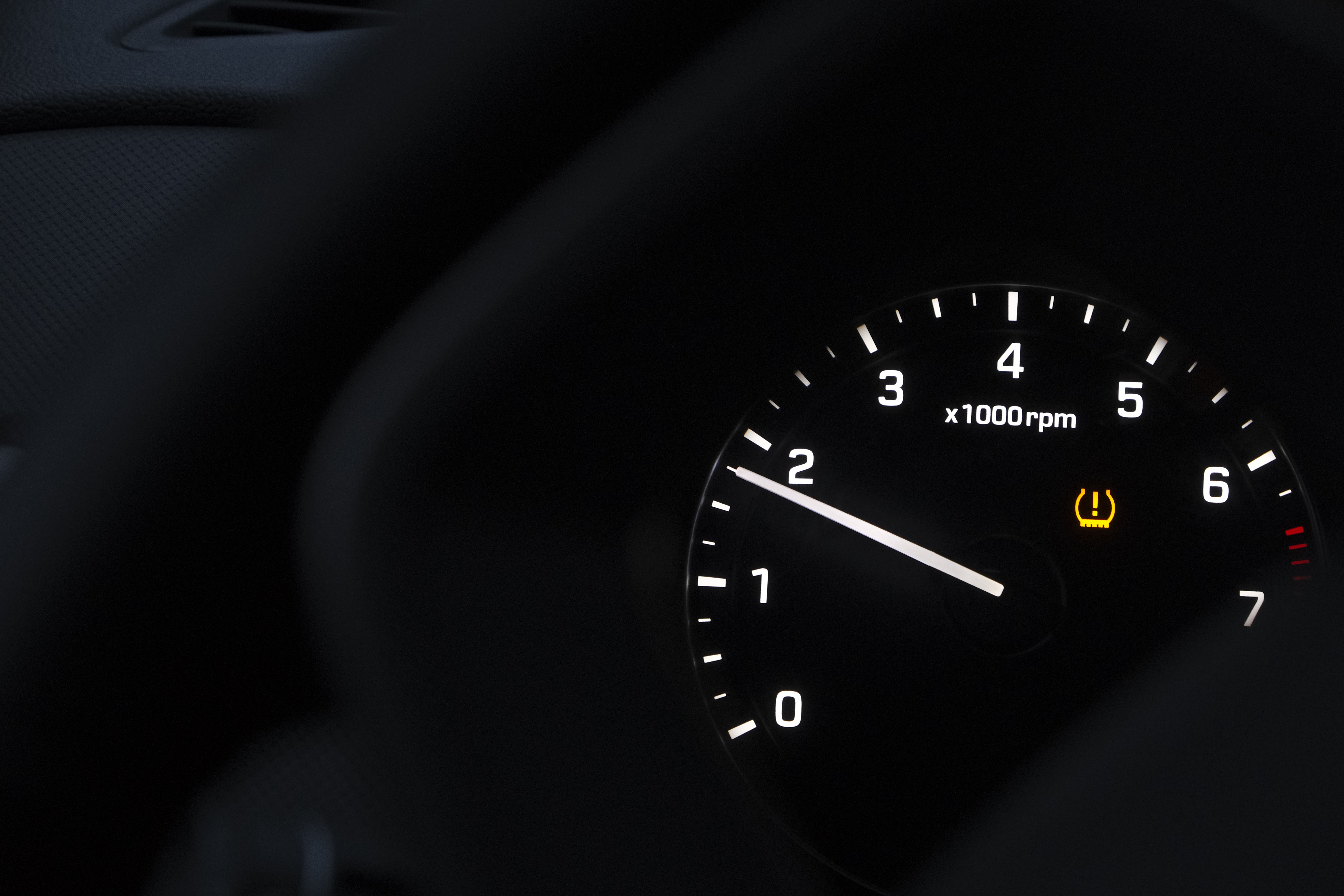 TPMS tire pressure warning symbol illuminated on a car dashboard